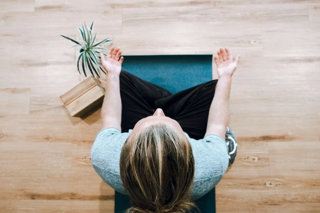 Women meditating on yoga mat for body scan meditation